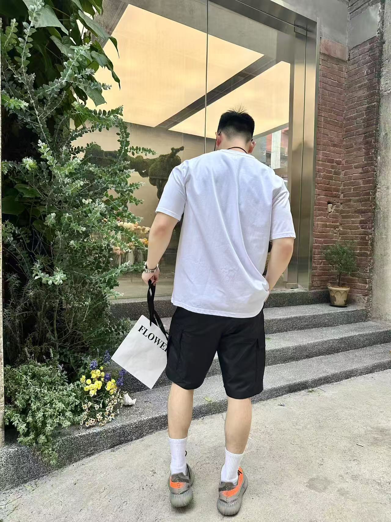 Black knee-length shorts on model, back view