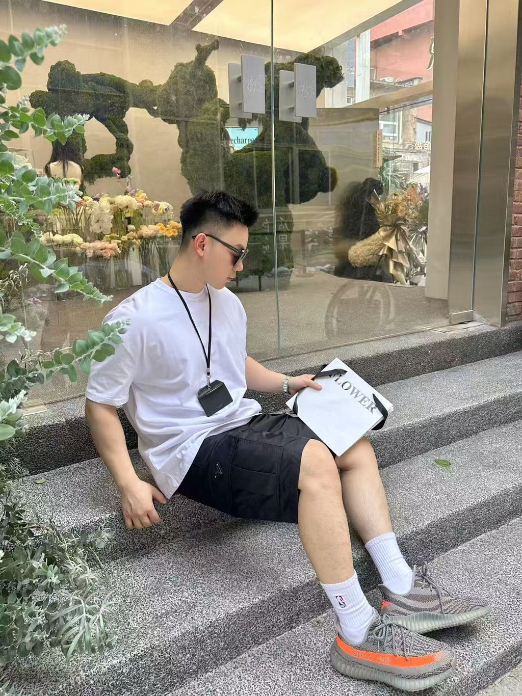 Black knee-length shorts, seated side view