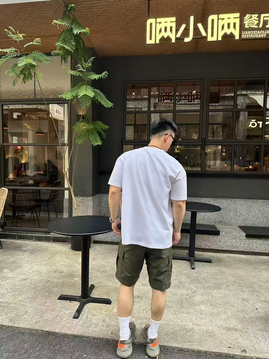 Olive cargo shorts, back view with straight hem and patch pockets
