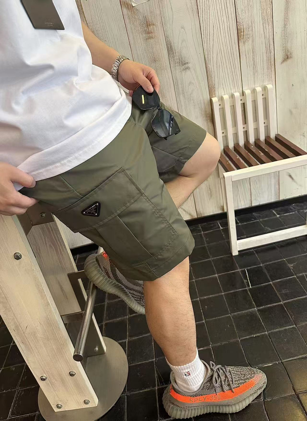 Olive cargo shorts close-up: side pocket and belt loops