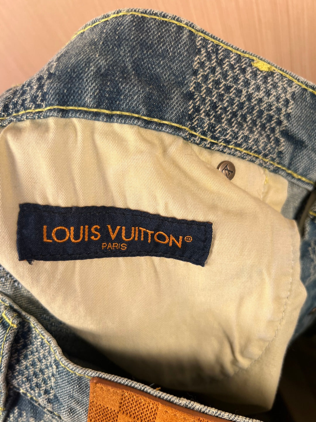 Louis Vuitton logo label on cream inner waistband of denim shorts pants