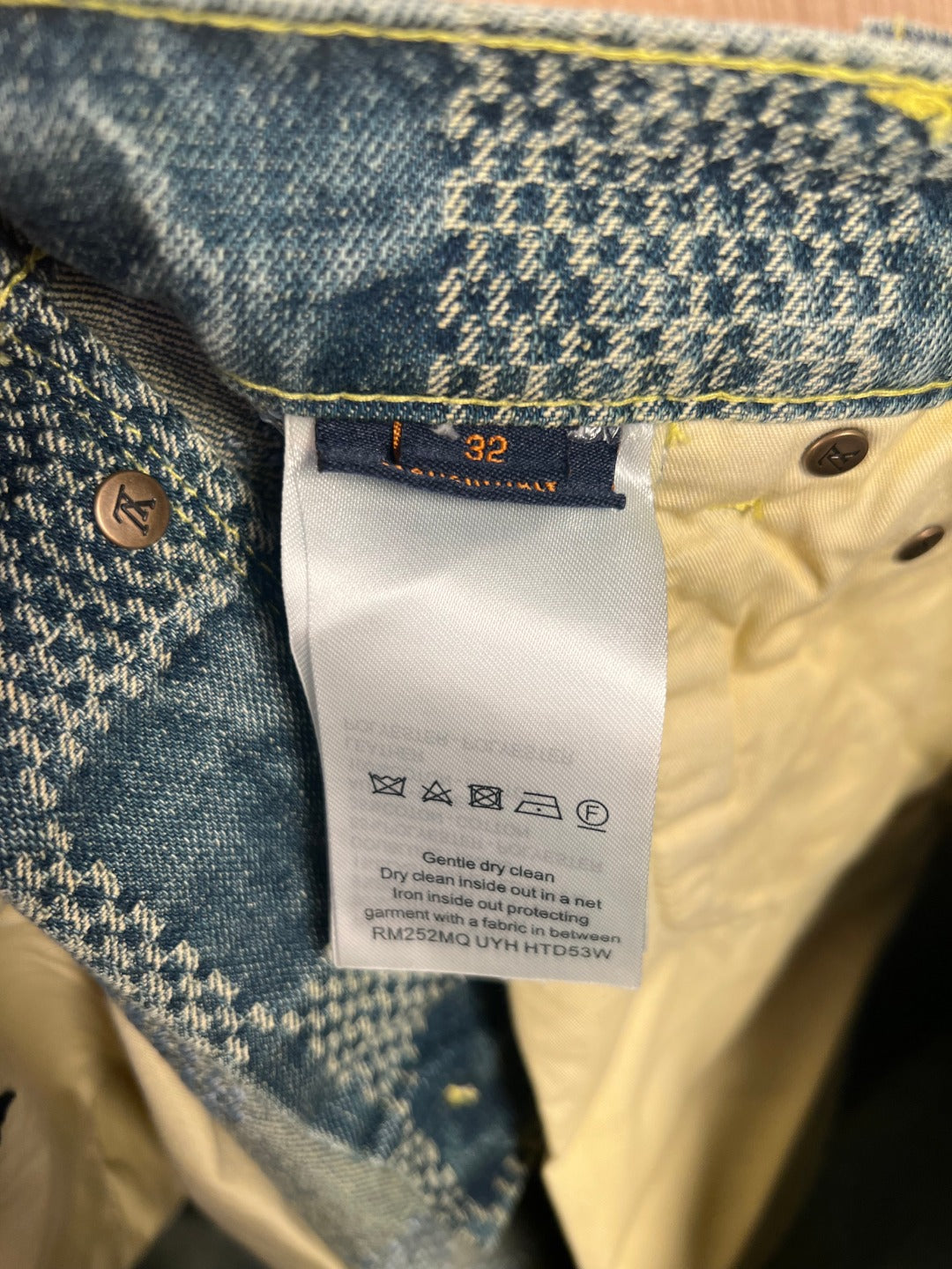 Denim shorts pants care and size label on cream interior lining