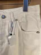 White denim pants close-up of front pockets and metal buttons
