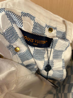 White denim pants inner waistband with blue check label and brand text