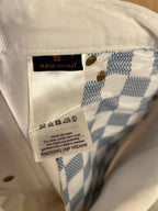 White denim pants care label with size 32 and made in Italy