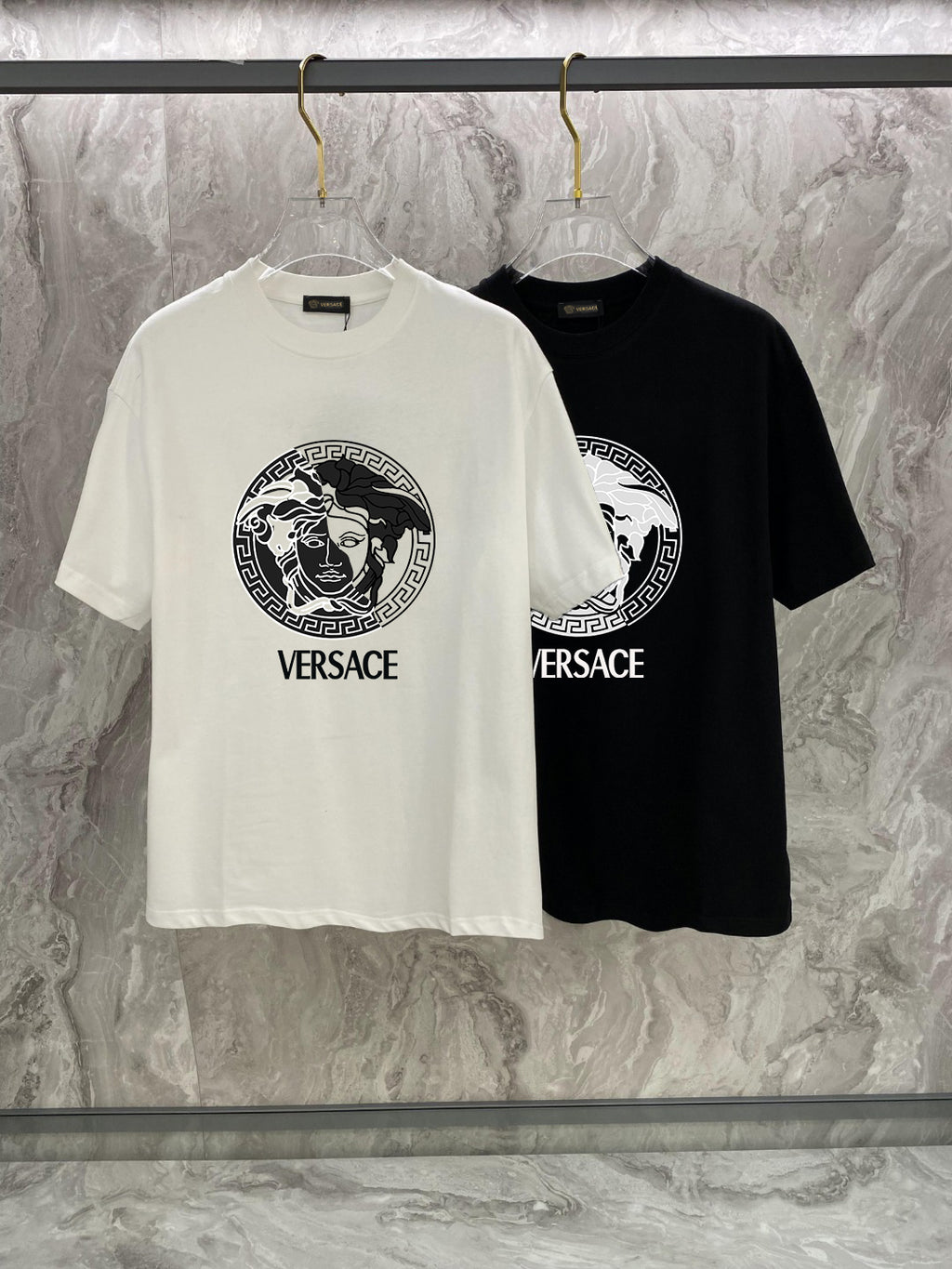 White and black Versace crewneck T-shirts with Medusa logo and VERSACE text