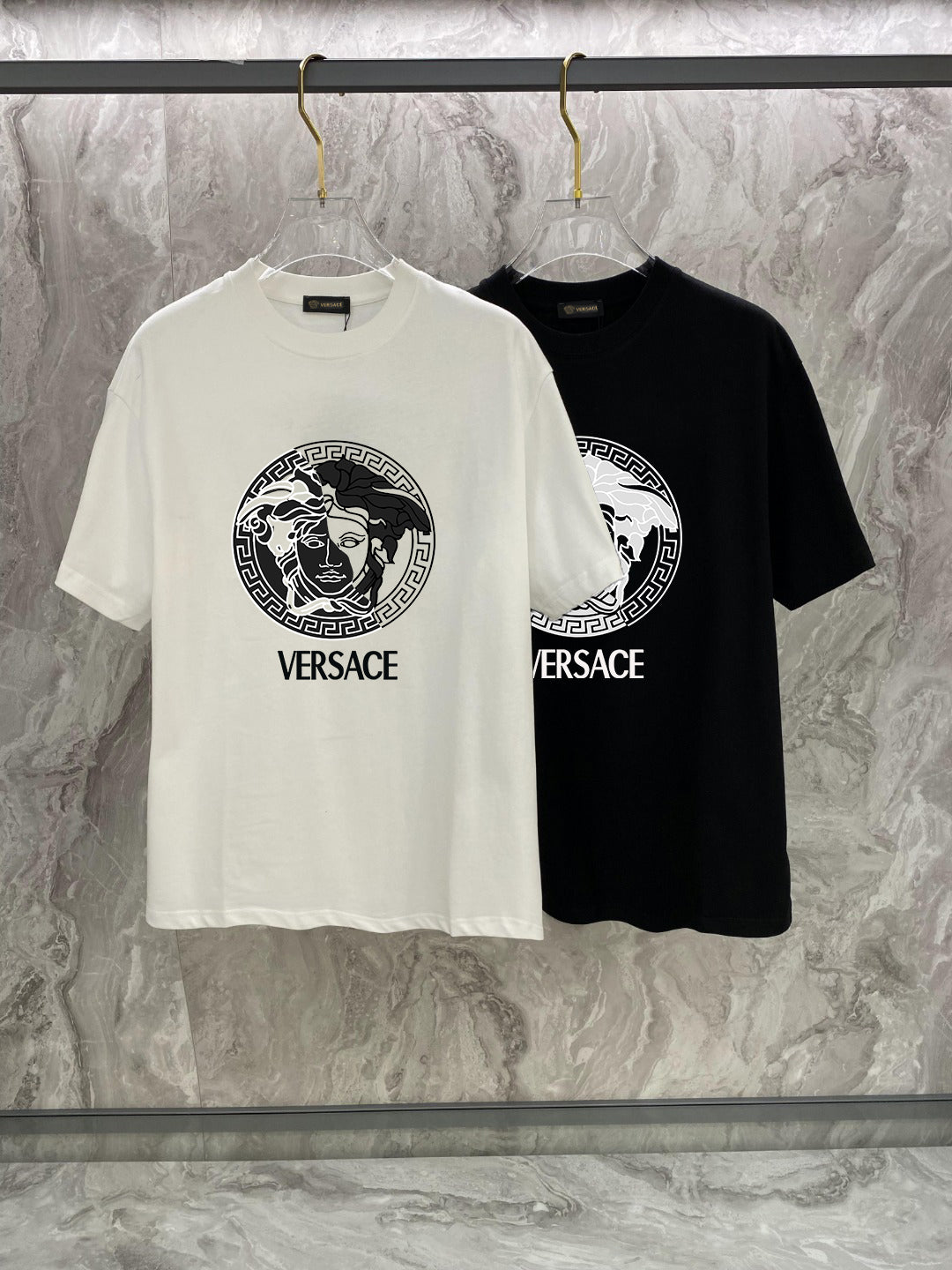 White and black Versace crewneck T-shirts with Medusa logo and VERSACE text