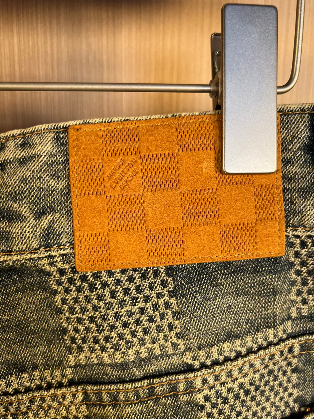Denim waistband lining with orange check patch label holder at top