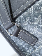 Goyard shoulder bag close-up of stitched trim and leather tab with metal ring