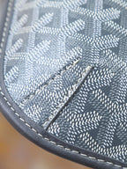 Goyard shoulder bag close-up of monogram canvas panel with stitched leather edge