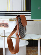 Goyard crossbody bag angled view with shoulder strap and monogram canvas body.