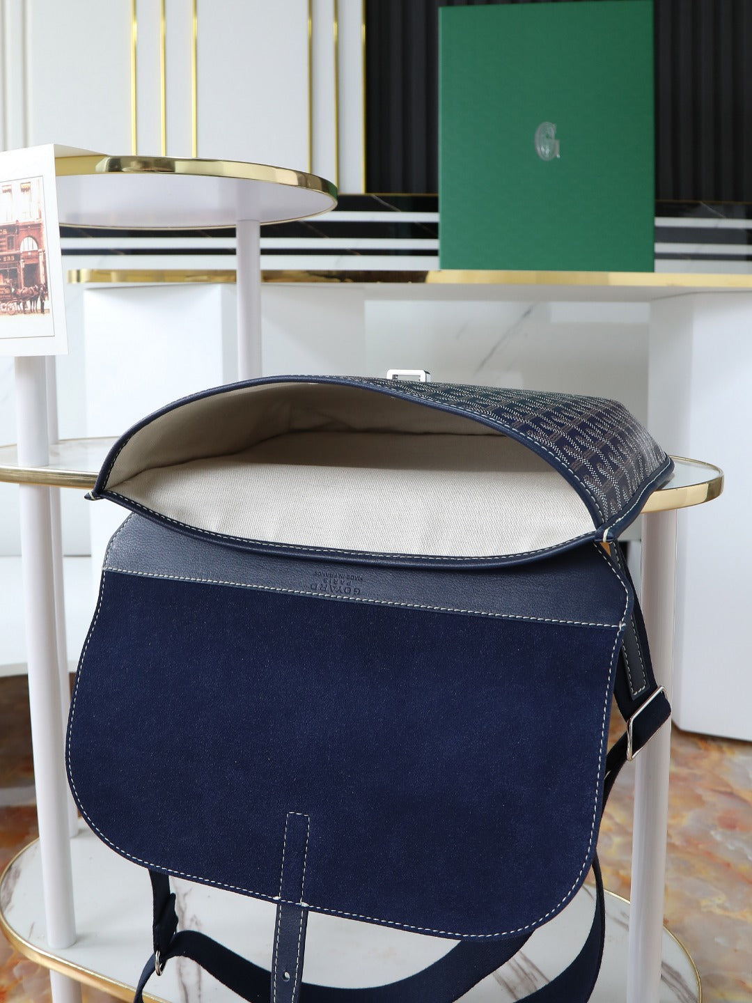 Goyard crossbody bag in dark blue with rounded flap opening and monogram trim