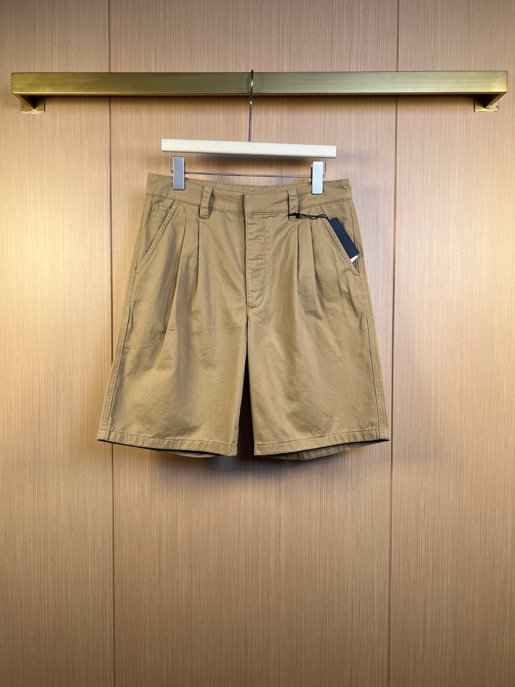 Khaki Prada shorts with belt loops, front pleats, and side pockets