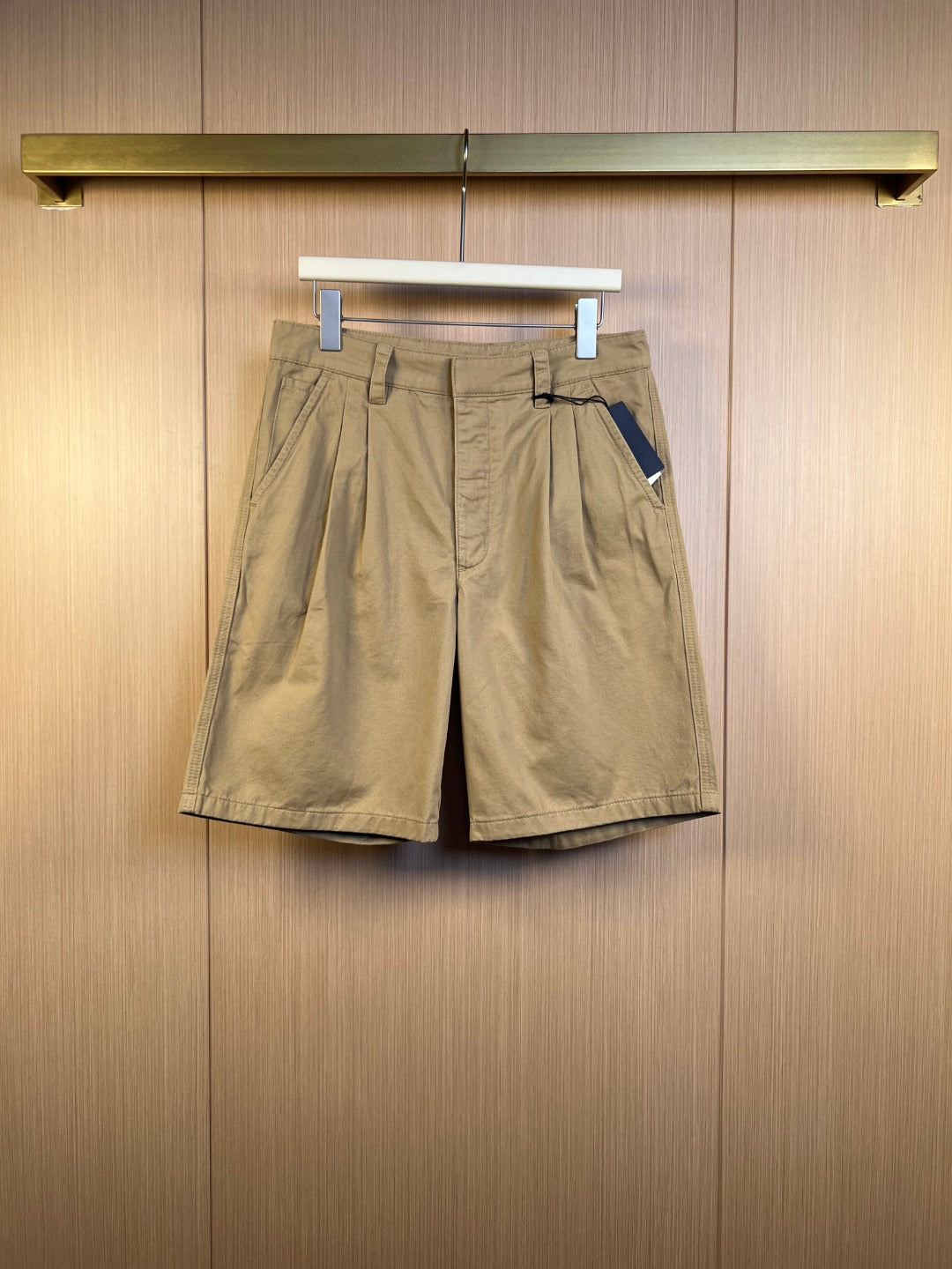 Khaki Prada shorts with belt loops, front pleats, and side pockets