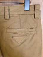 Khaki Prada shorts with flap back pocket and triangular stitched detail