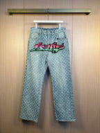 Light blue monogram denim pants with colorful graffiti graphic on the front
