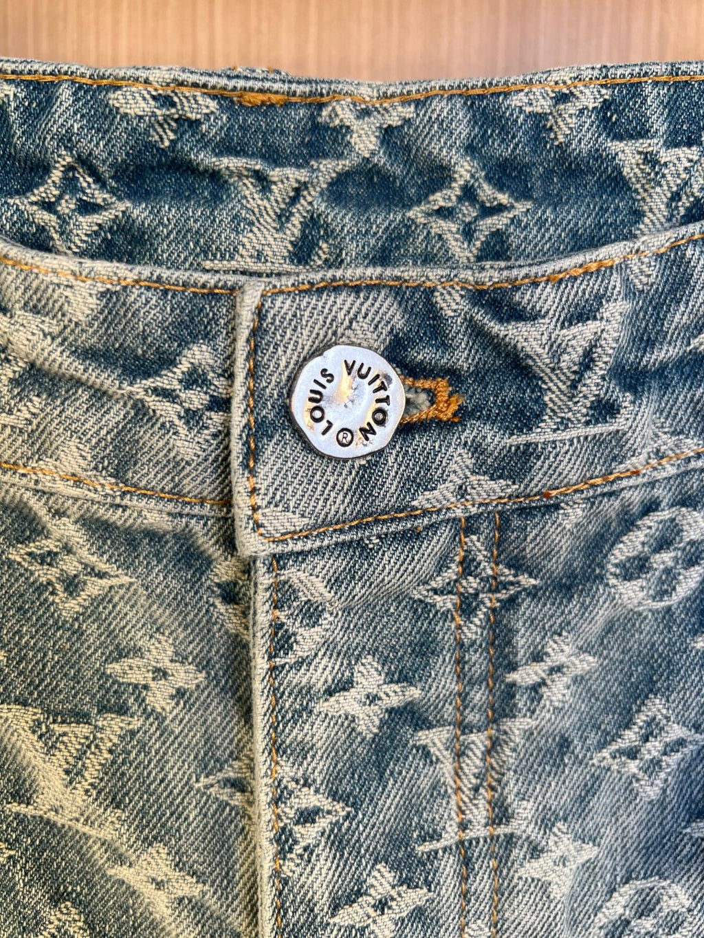 Blue denim pants close-up of waistband and interior logo patch