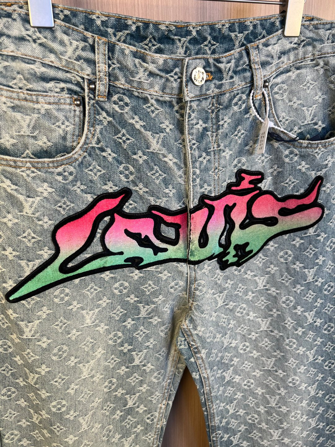 Light blue monogram denim pants with colorful graffiti graphic and front fly