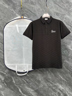Black Gucci polo shirt with short sleeves, collar, button placket, script logo