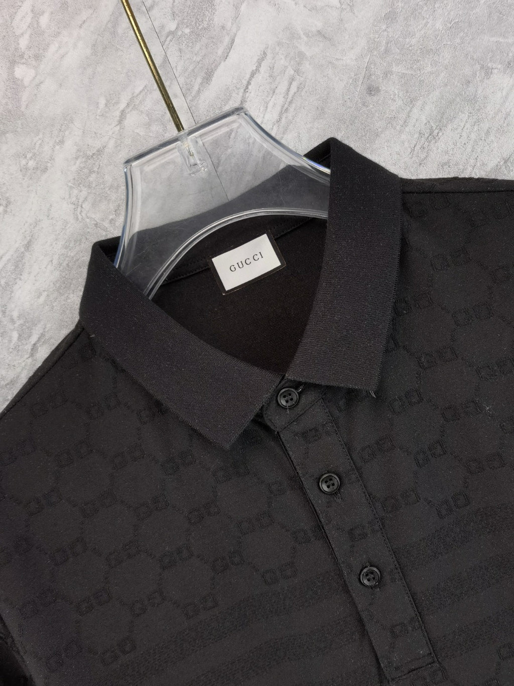 Black Gucci polo shirt neckline close-up with inner label and collar buttons