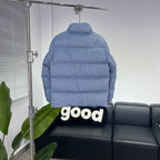 Light blue puffer jacket back view with hood and quilted horizontal stitching