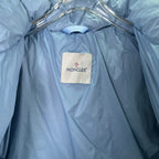 Light blue puffer jacket with inner collar label and smooth quilted lining