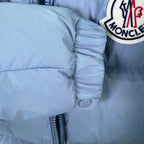 Light blue padded sleeve cuff with snap button and quilted baffles