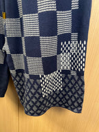 Navy shorts with patchwork squares and patterned hem detail
