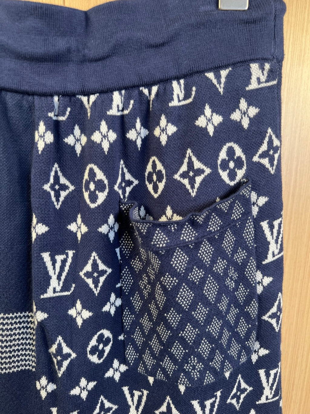 Navy shorts with allover monogram print and front pocket detail
