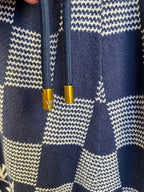 Navy shorts with check patch seams and drawcord tips, knitted fabric
