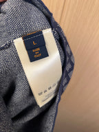 Navy shorts inner tag labeled Made in Italy, fabric seam close-up