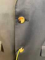 Gucci gold-tone button on dark blazer cuff