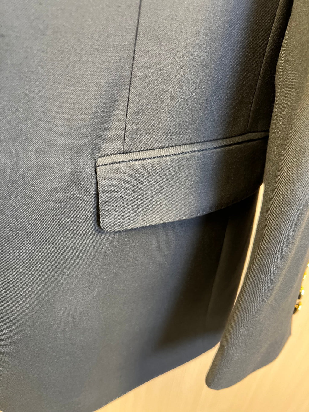 Dark blazer pocket with stitched flap