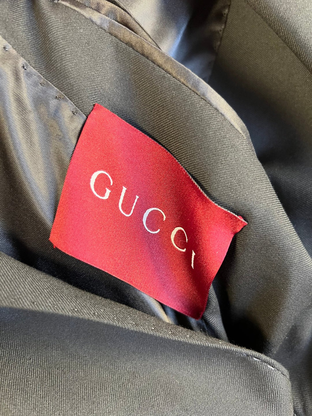 Gucci red interior label on dark blazer lining