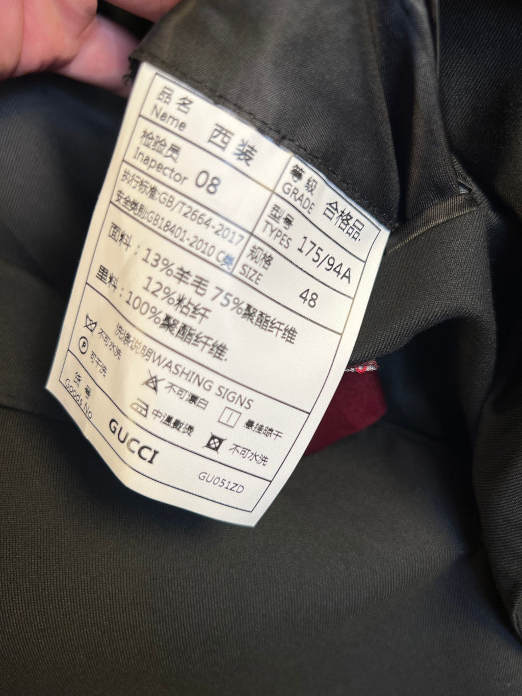 Gucci fabric care and size tag on dark blazer lining