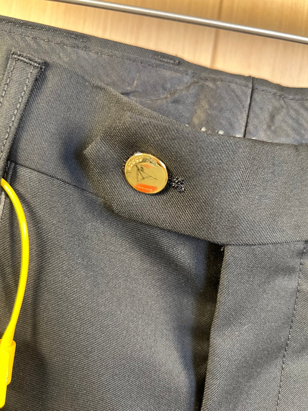 Gucci trousers waistband close-up with button closure and belt loops