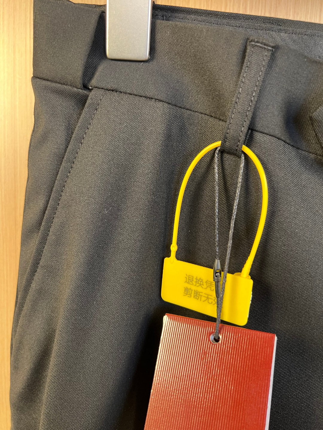 Gucci trousers front pocket area with belt loops and hanging tag