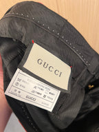 Gucci fabric label and care instructions inside black trousers