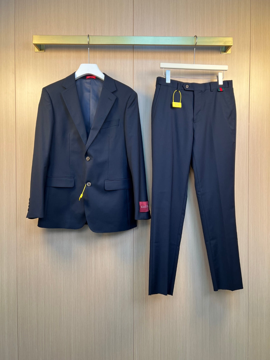 Navy Gucci suit jacket and matching trousers with button front and pockets