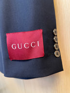 Navy blazer sleeve cuff with Gucci label and gold-tone button details