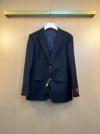 Navy suit jacket with notched lapels, flap pockets, and button front
