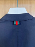 Navy suit jacket back collar with green and red web detail
