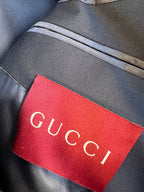 Red Gucci brand label on dark fabric trim
