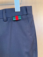 Dark navy pants waistband and fly detail with green-red stripe designer tag