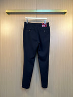 Dark navy pants on hanger with belt loops and front button closure