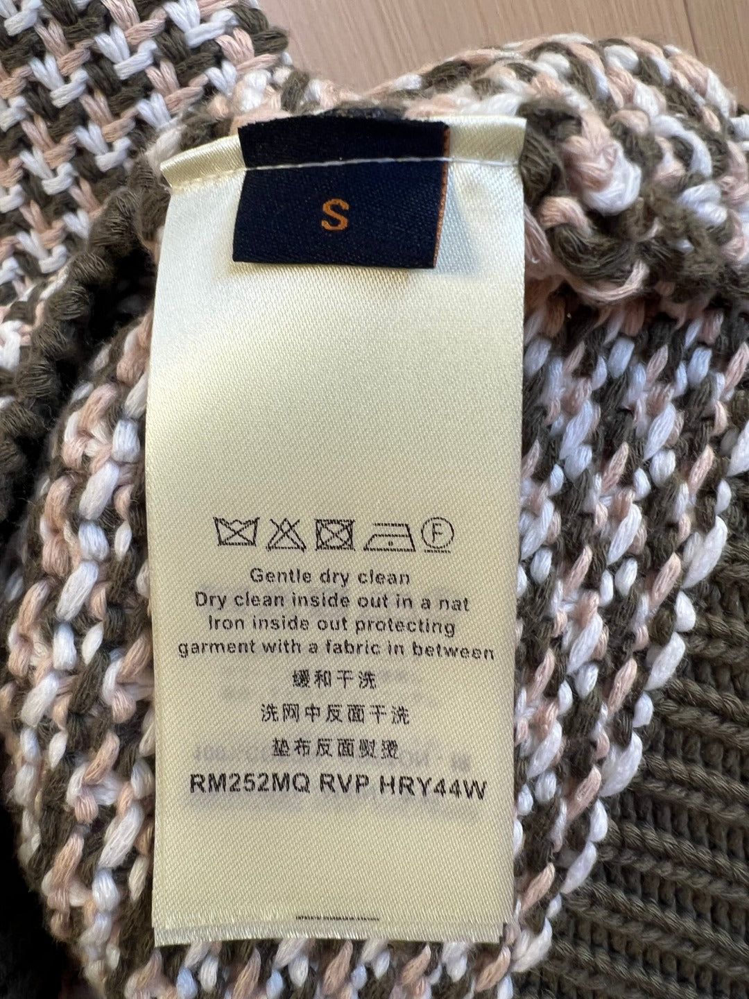 Louis Vuitton garment care label on knit fabric, size S