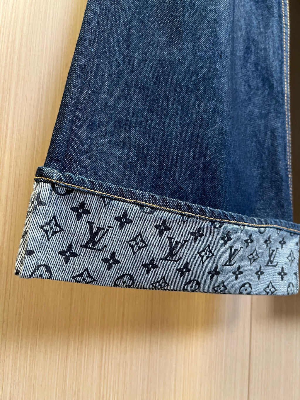 Denim pants cuff with monogram-print patterned trim and contrast yellow stitching