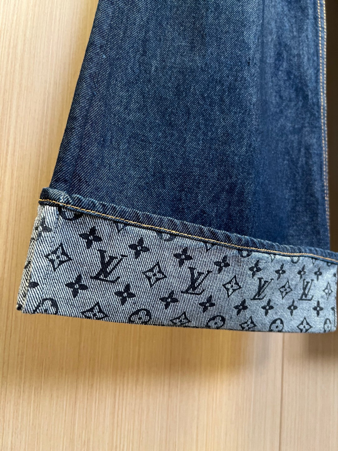 Denim pants cuff with monogram-print patterned trim and contrast yellow stitching