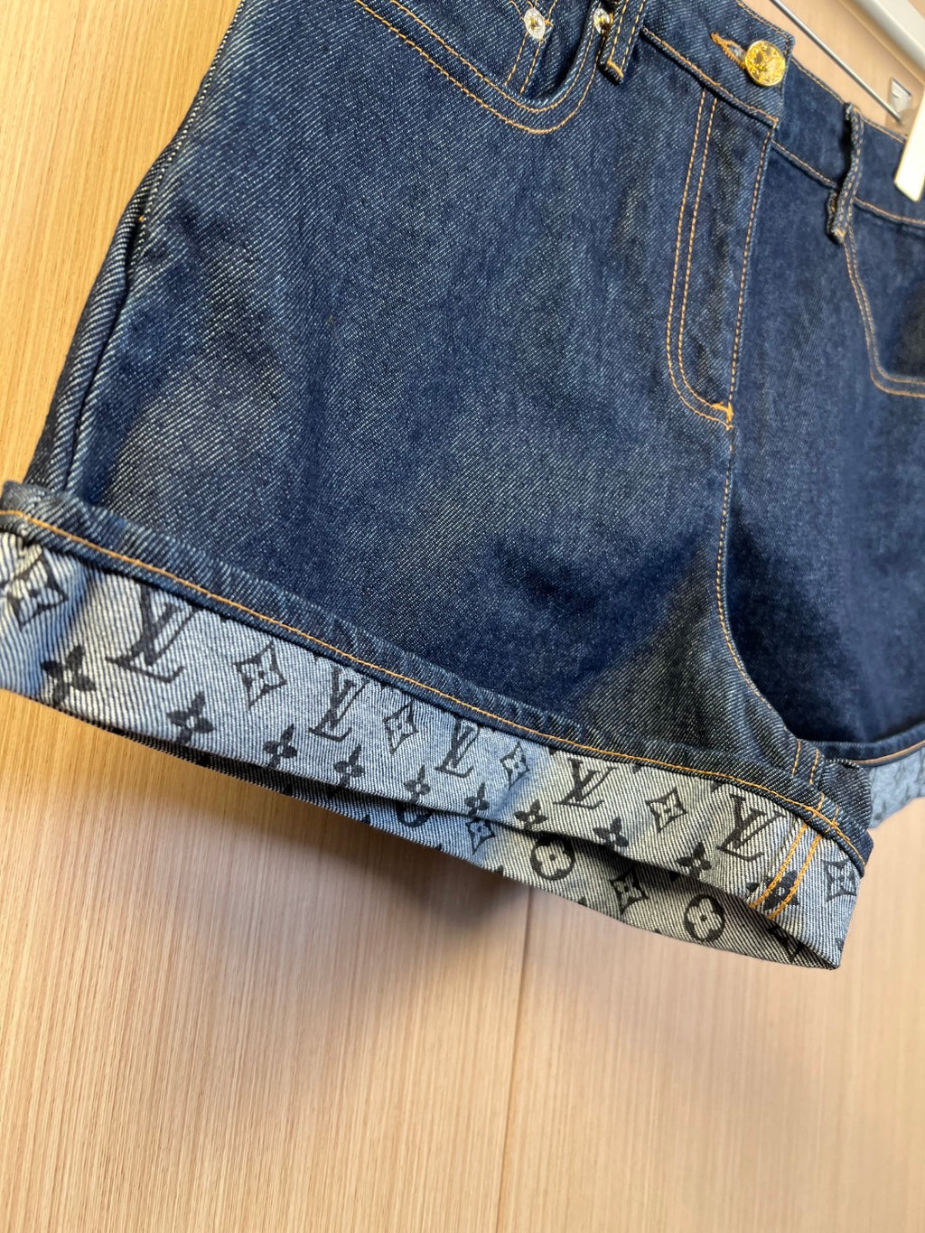 Louis Vuitton denim shorts front with pocket stitching and monogram cuff hem