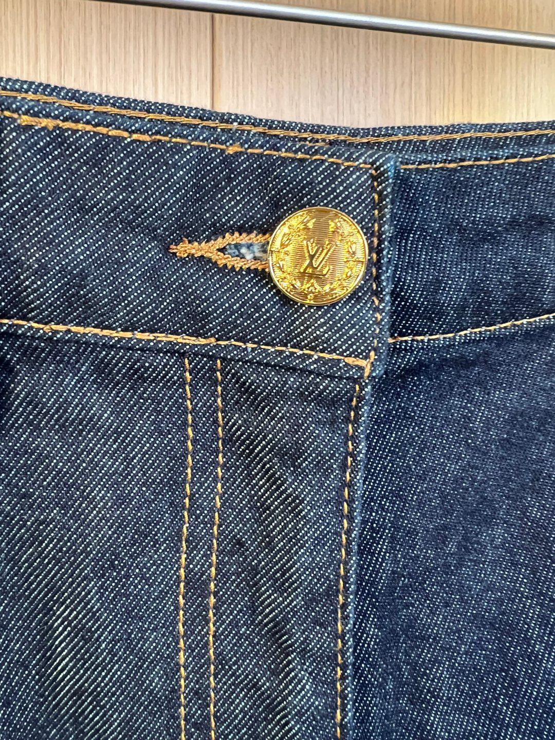Louis Vuitton denim shorts button with gold-tone hardware and contrast stitching